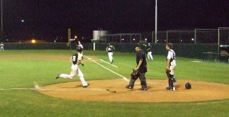 Image: Josh Milligan — Milligan scores after hitting in Matt Brummett and Colten Campbell.