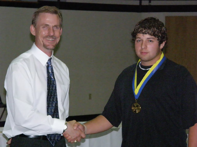 Image: Ivan pulls it off — Ivan Roldan receives his first year award.