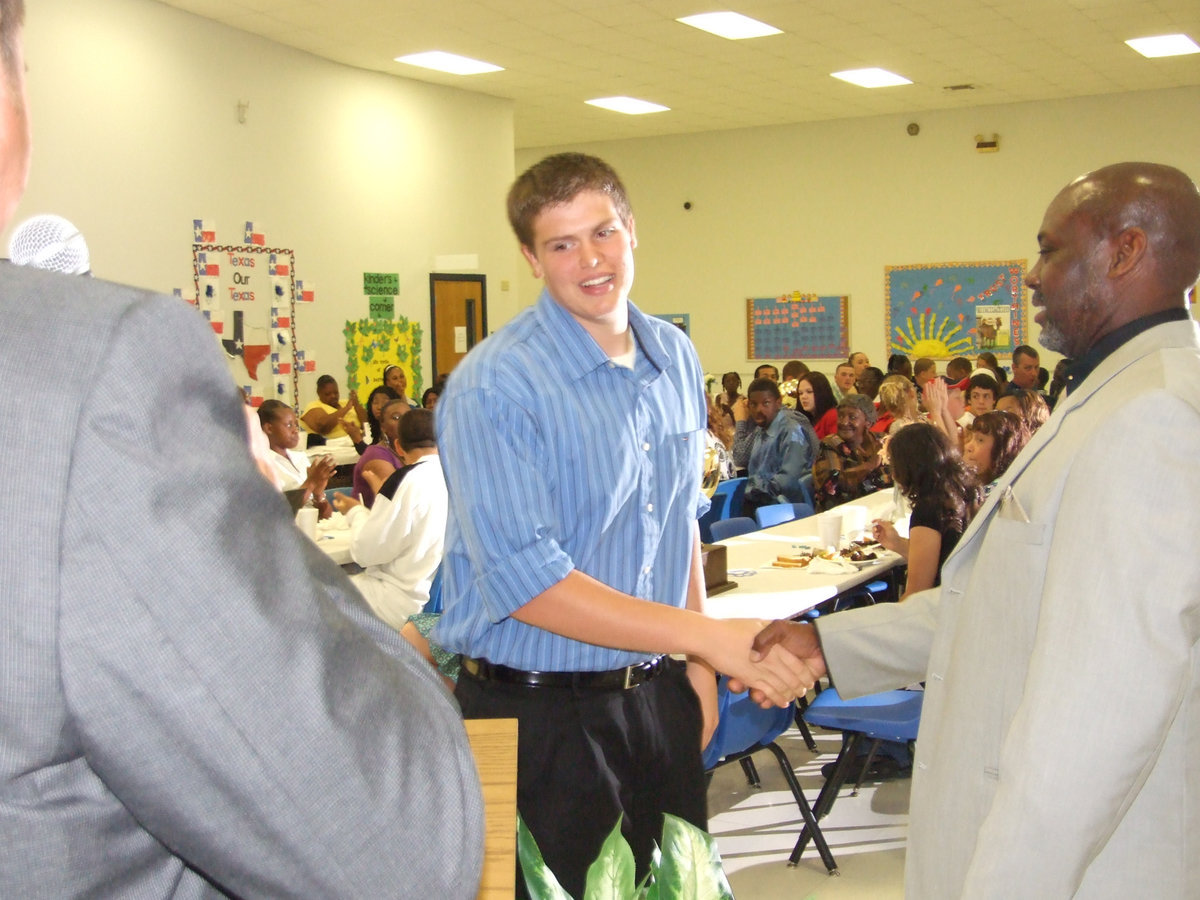 Image: Eric’s future is bright — Coach Carter congratulates a member of his J.V. Basketball squad, Eric Johnson.