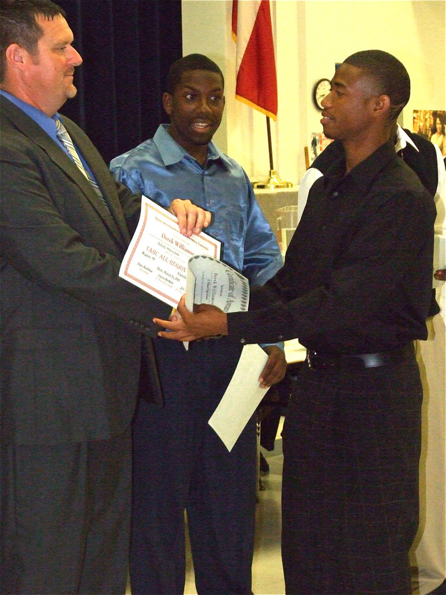 Image: Nice job, Derek! — Coach Ronny Crumpton congratulates Derek Williamson.