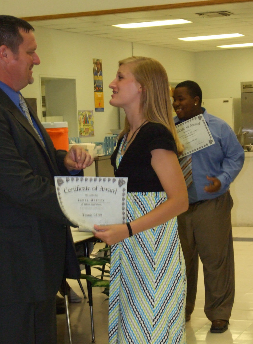 Image: Laura Harvey — Coach Ronny Crumpton congratulates Laura Harvey.