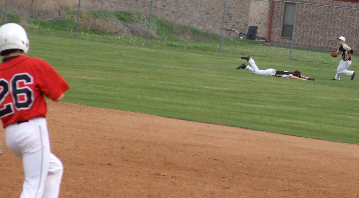 Image: Not quite — This Longhorn hit too far too the left for center fielder Jase Holden.