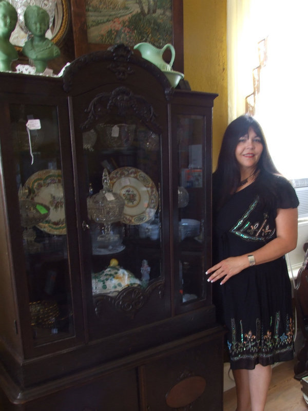 Image: Carlene Hunt-Perryman — Carlene (owner) is standing buy one of her beautiful antique hutches.