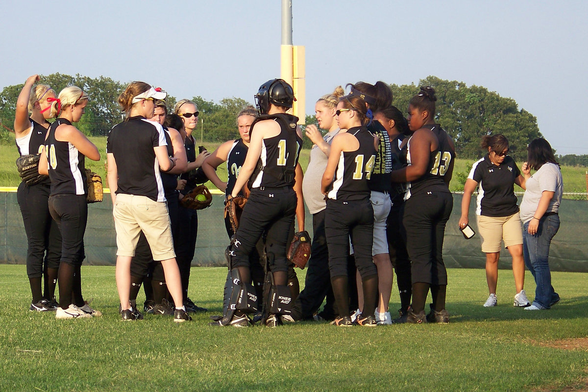 Image: Huddle — Before their first time in the field, Coach Reeves pumps up the defense.