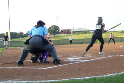 Image: Down the line — Courtney Westbrook hits a “swunt” down the first base line.