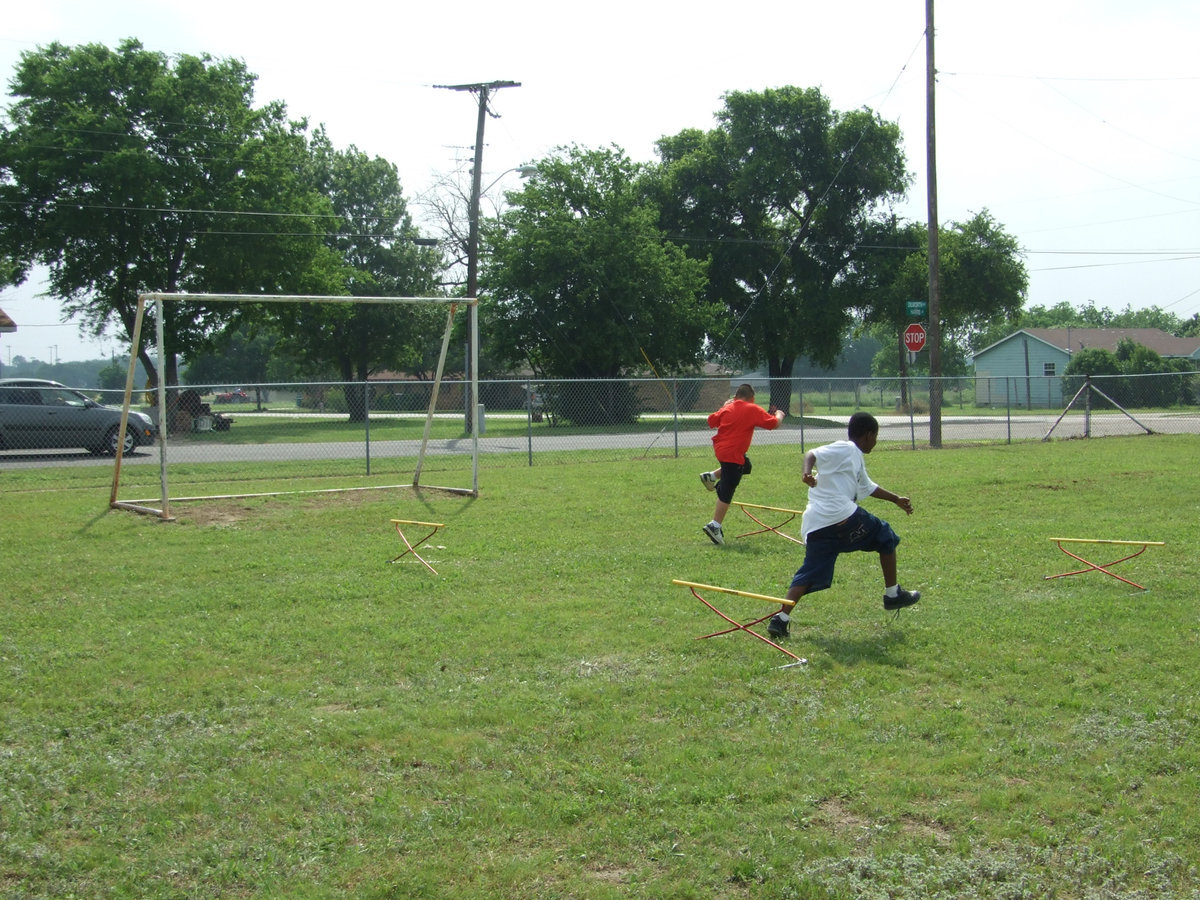 Image: Tiki Trail — “It is basically a relay, they run through the hoops, jump the hurdle turn around at the tiki torch and they com back and the first one back is the winner.”