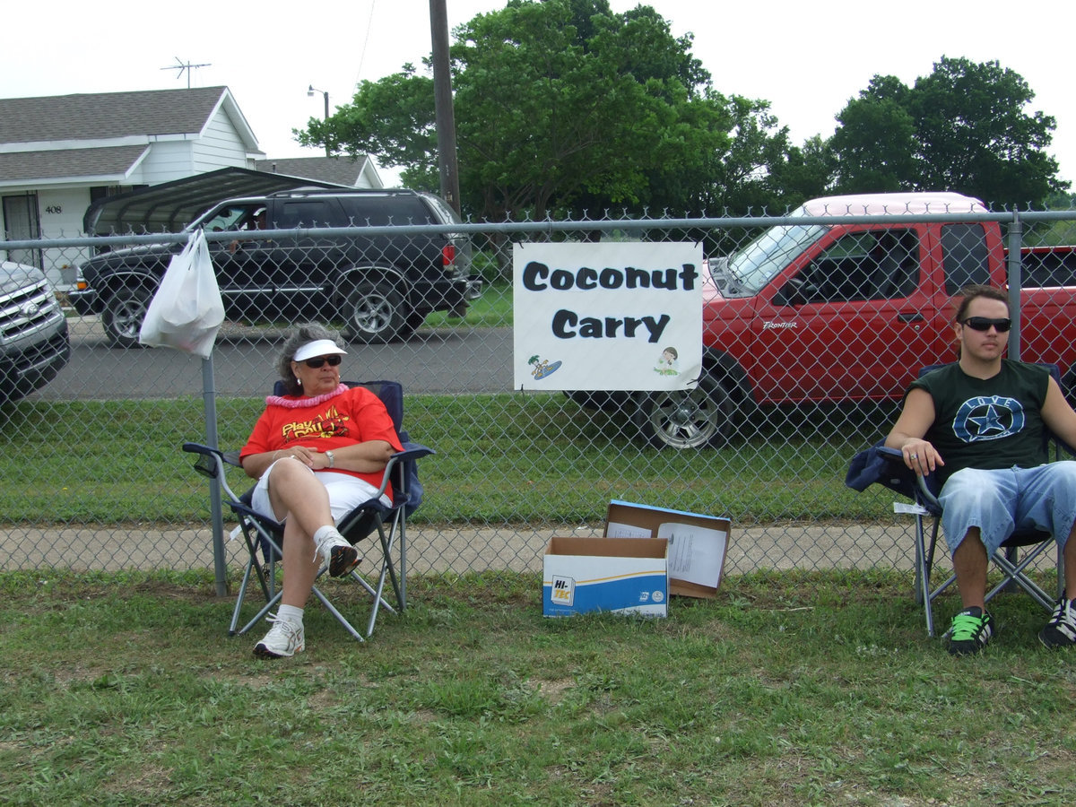 Image: Mrs. Jacinto and Zach Hernandez — “You get a coconut and put it in between your legs and run to the cones and turn around and run back. We have two different teams and whoever finishes first is the winner,” explained Mrs. Jacinto (ESL assistant).