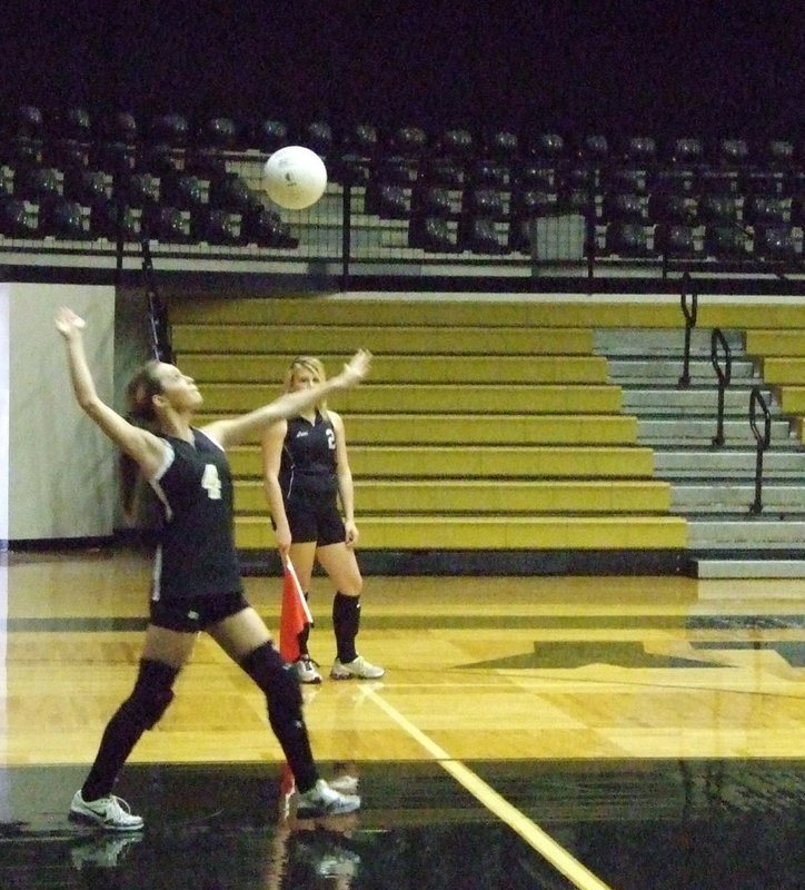 Image: Drew serves — Drew Windham serves the ball to Red Oak.