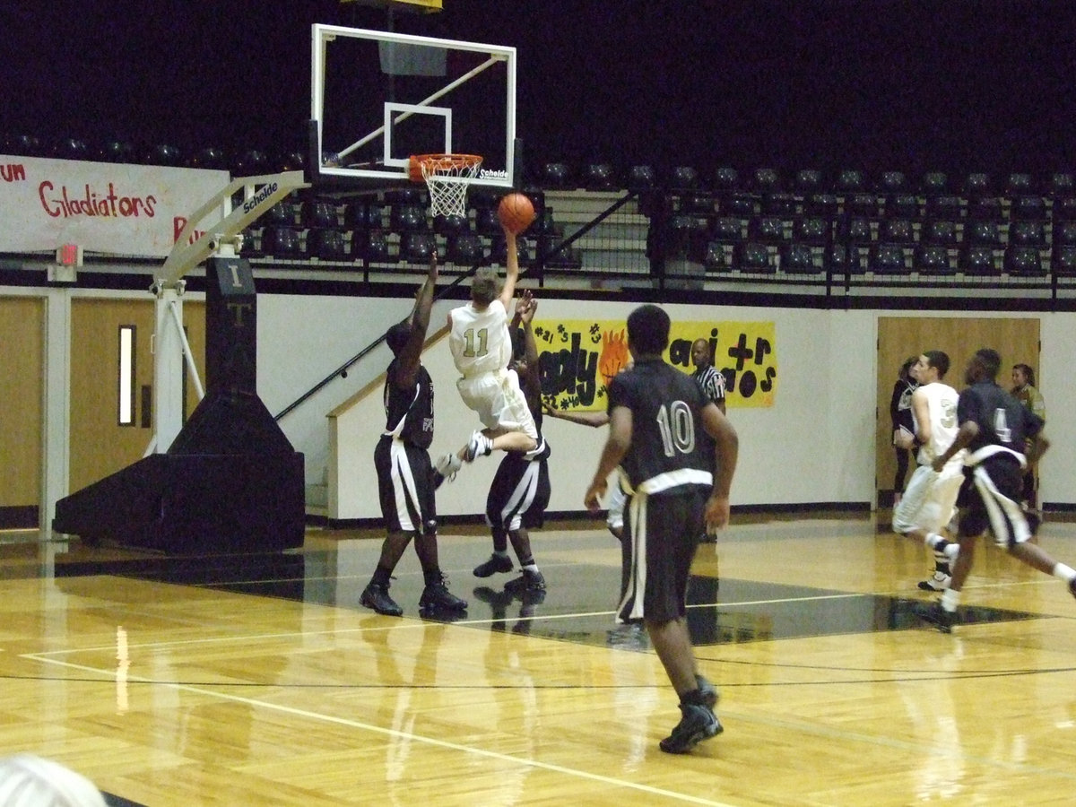 Image: Jase jumps — Italy’s #11 Jase Holden rises between two defenders.