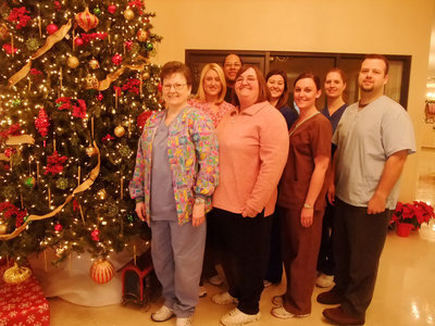 Image: Therapy Staff  — Caroline Powell (activities director), therapy staff and Chris Baker in the back all invite you to the Christmas open house.
