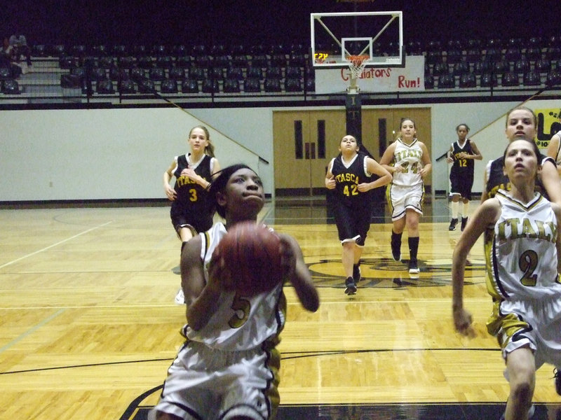 Image: Jameka finishes — Finishing off another fast break against Itasca is #5 Jameka Copeland.