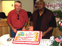 Image: Fire Chief Donald Chambers and Mayor Jackson display the cake — Italy Fire Chief Donald Chambers is honored with a retirement reception hosted by Mayor Frank Jackson and fellow City of Italy employees.