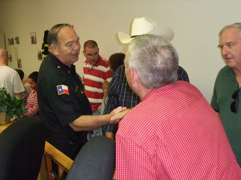 Image: Chief to Chief — Italy Police Chief C.V. Johns wishes retired Italy Fire Chief Don Chambers the best of luck.