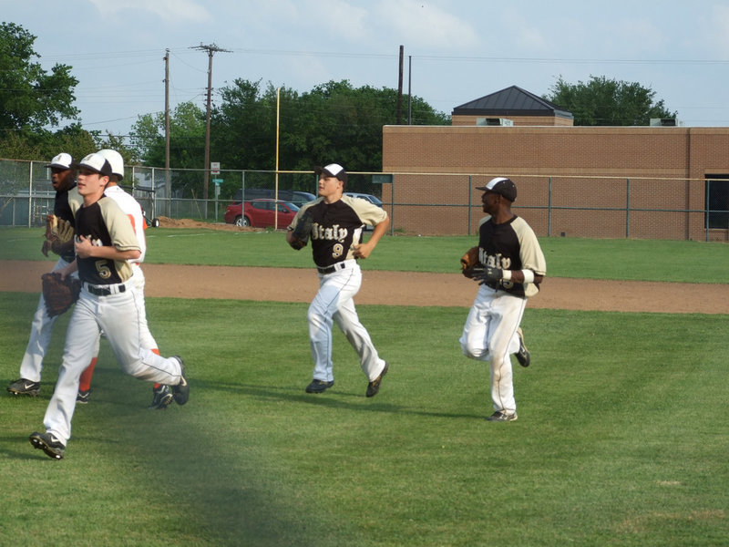 Image: Outfield is in — Switching the inning, the Gladiators come in to the dugout.  They are ready for play-offs.