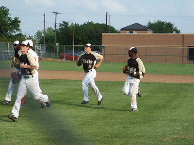 Image: Outfield is in — Switching the inning, the Gladiators come in to the dugout.  They are ready for play-offs.
