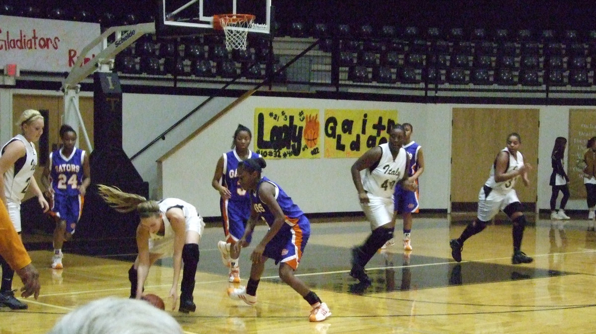 Image: Becca Scoops — Becca scoops up the ball on the way to the hoop.