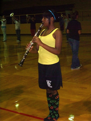 Image: Jameka Jams — Jameka Copeland on clarinet while wearing very loud peace socks.