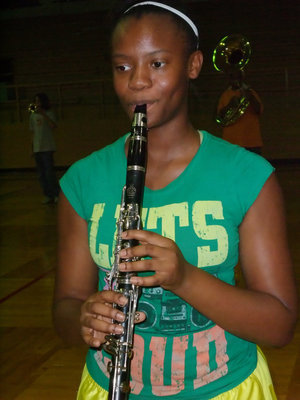 Image: Step…step…tweet — Brianna Burkhalter practices marching while playing the clarinet.