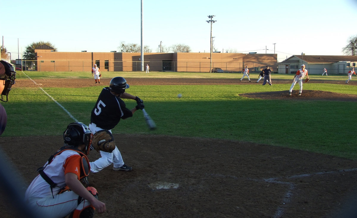 Image: He let’s ’em have it — Reid Jacinto gives that ball a hit to center field.