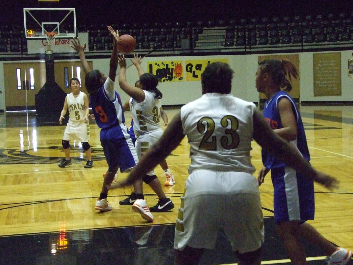 Image: Davis passes — Passing out of trouble is point guard Khadijiah Davis #34.