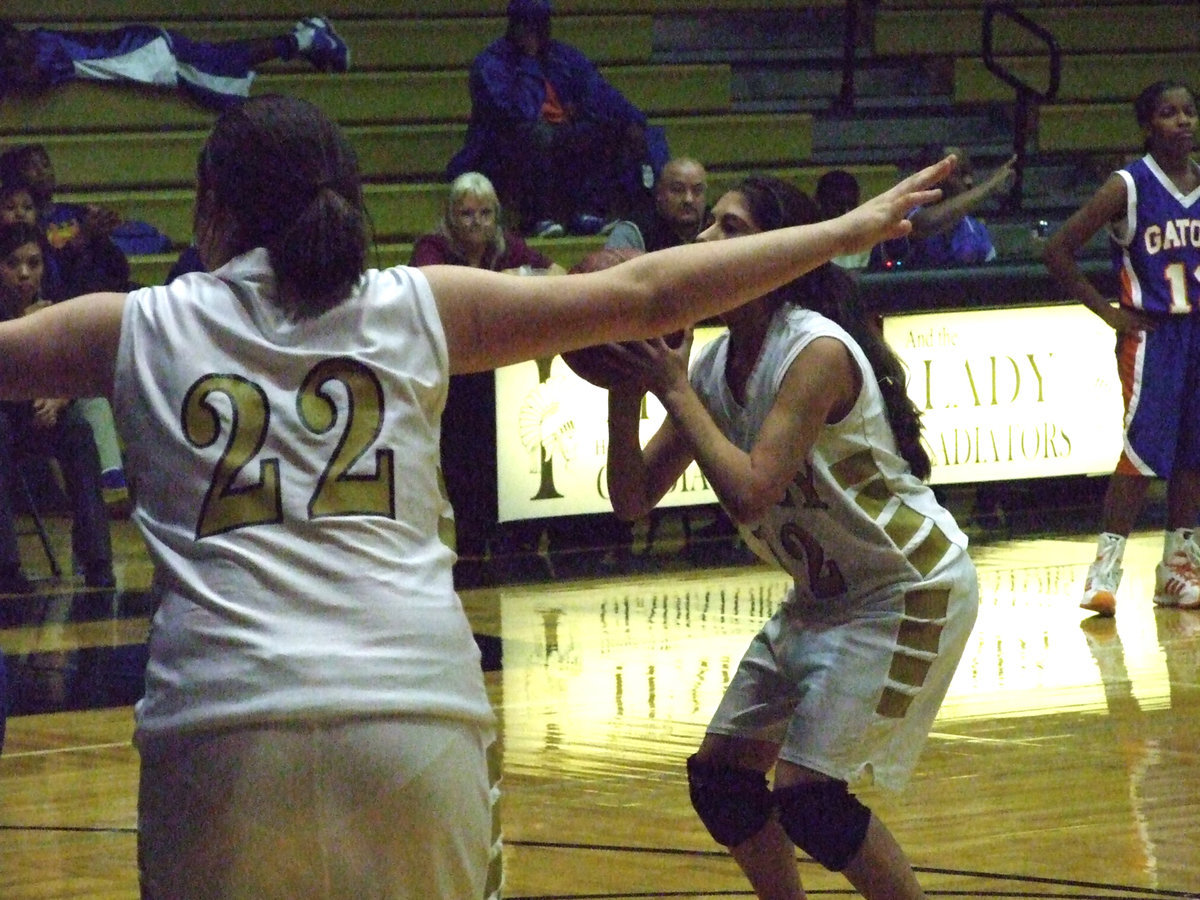 Image: Alma Suaste — Teammate #22 Kaytlyn Bales keeps the photograghers back while #12 Alma Suaste drills a free throw.