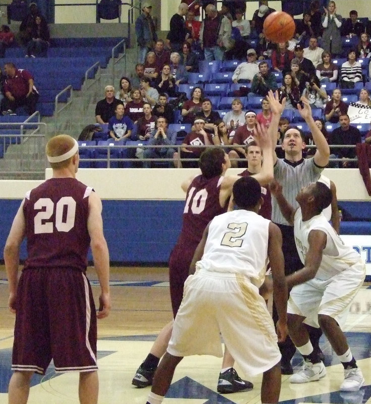 Image: Tip-off — Gladiator Larry Mayberry(13) jumps high against Mildred’s Hayden Pritchett.