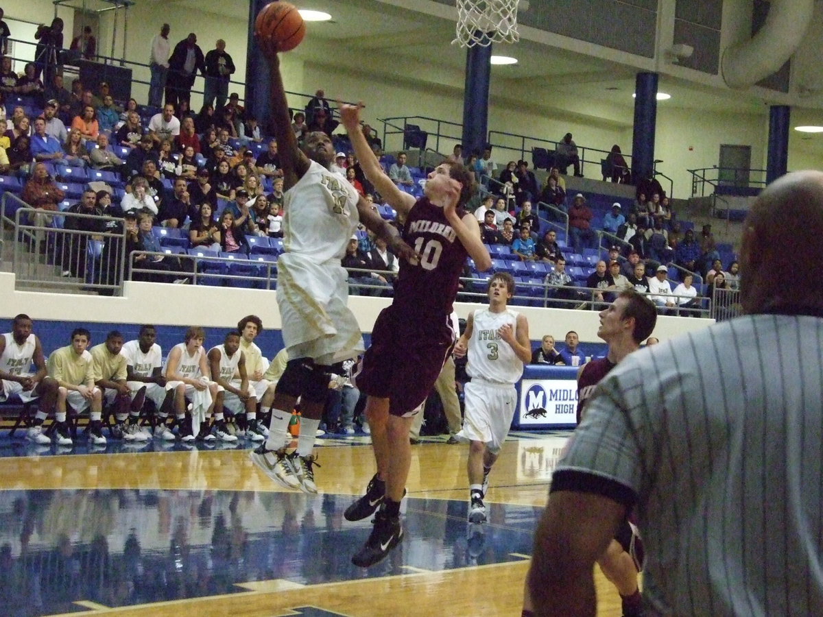 Image: Jasenio up — Relentlessly, Jasenio Anderson(11) attacks the Mildred basket. Anderson hit 10-of-12 free-throws including six straight in the fourth-quarter to end Mildred’s season.