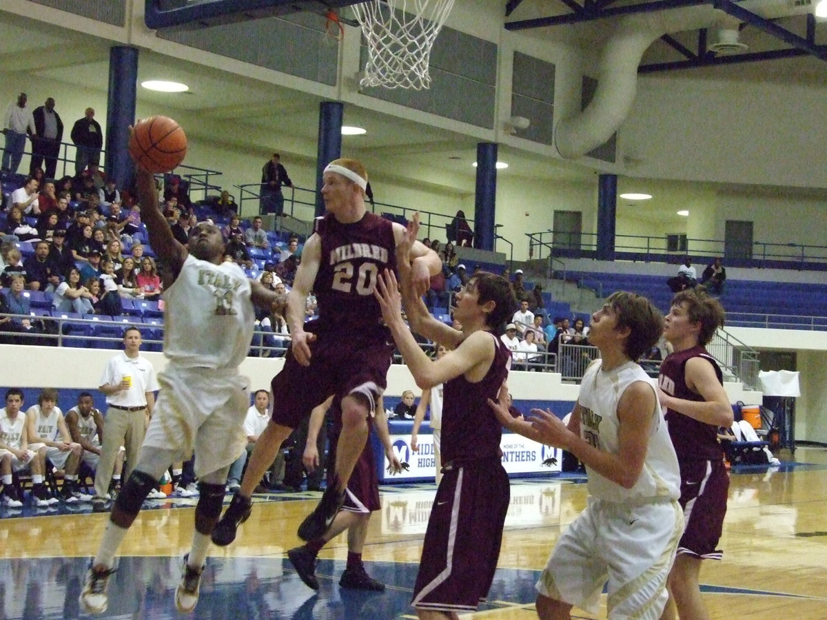 Image: Jasenio’s night — Jasenio Anderson(11) drives in the lane reserved for just him as teammate Cole Hopkins(21) gets in rebounding position.