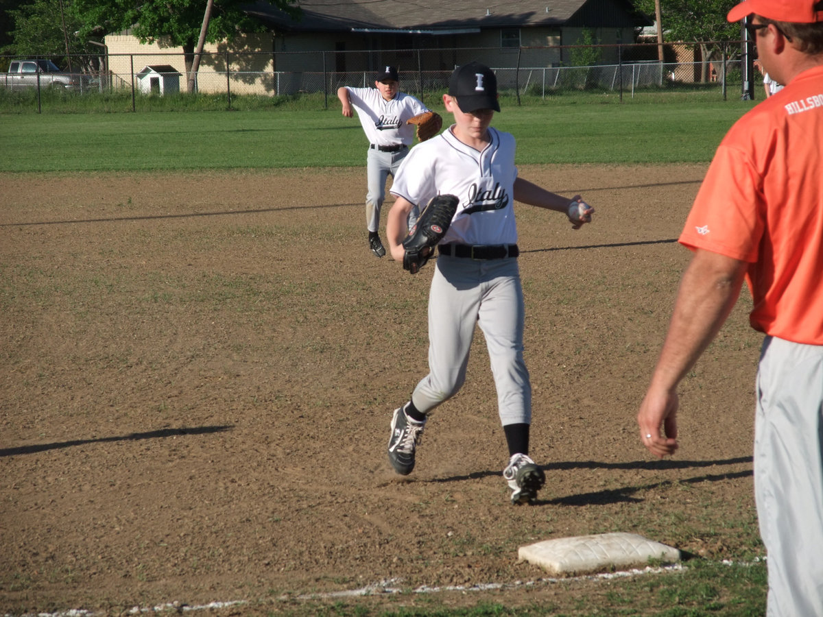 Image: Cody Boyd — First Baseman Cody Boyd stops the grounder and tags the base for an out.