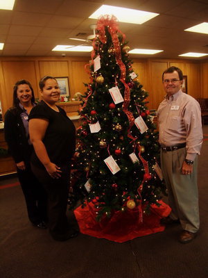 Image: First State Bank Employees — Jennifer Buchanan, Nichole Galvan and Mike Boyd are in the Christmas spirit.