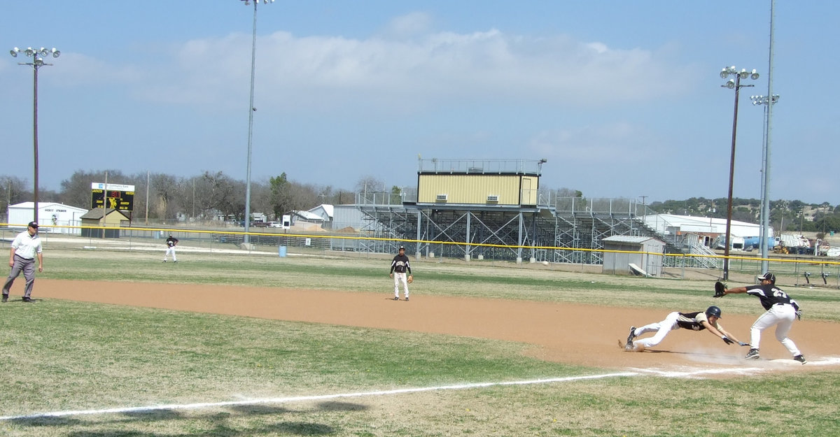 Image: Go back — Alex DeMoss works the pitcher and first base.