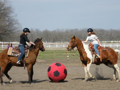 Image: Soccer Showdown — Elizabeth Terry, left, and Dakotah Van Huss both of Waxahachie, go head to head to get the soccer ball in a game of equine soccer at  the ECEYA meeting at the Flying Dollar Ranch in Italy.