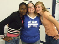 Image: Cheerleaders and Their Leader — Winona Crumpton (high school cheer sponsor) and two of her cheerleaders.