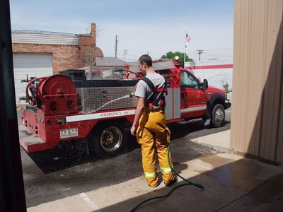 Image: Cleaning Brush 1 — The champ gets a hose down after the big fight compliments of Firefighter Eric Bradley.
