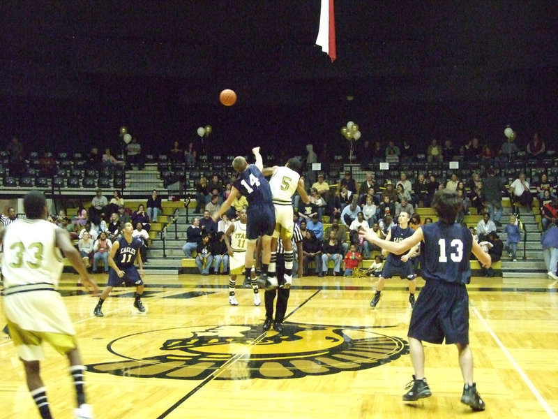 Image: Tip-off — Italy’s #5 Dontavius Clemons soars like an eagle against Waxahachie Advantage.