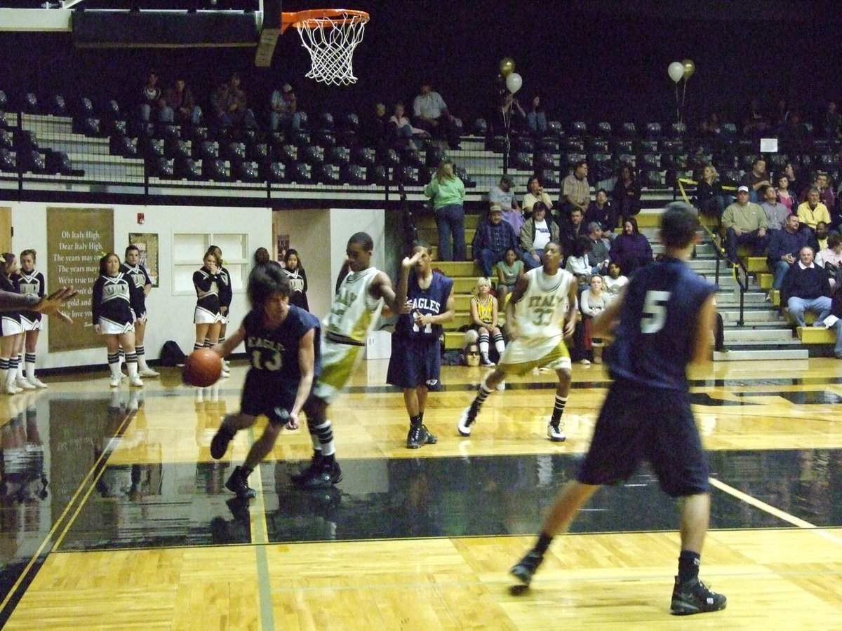 Image: Eagles try to fly — Italy’s Heath Clemons tries to show this wounded Eagle how to fly down court.