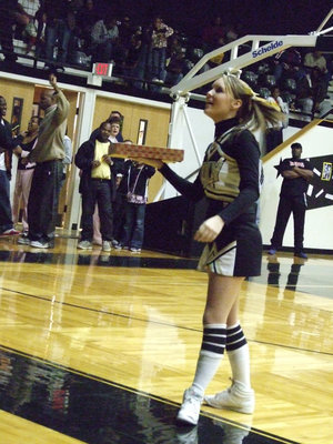 Image: Brogden searches for spirit — Lindsey Brogden worked the crowd at halftime.  She was looking for the most spirited fan to give a pizza to.