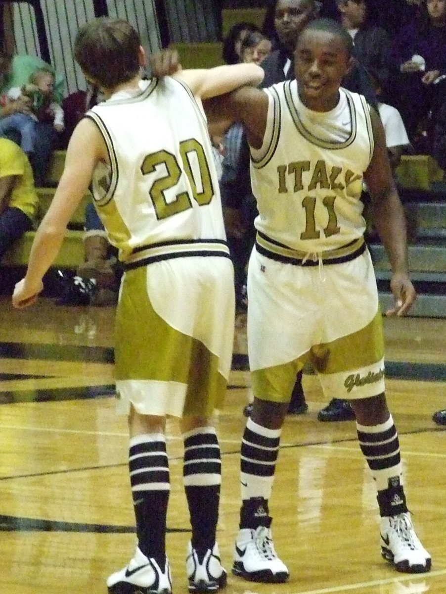 Image: Dan and Jasenio — Dan and Jasenio lock arms to show their unity before the game sporting their old school uniforms.