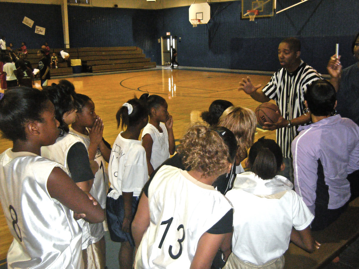 Image: Coach Elizabeth Evans and her team intently listen to the rules — The Mt. Moriah Christian’s 1st Annual Youth Basketball Tournament was held at the Milford Bulldog Gym this past Saturday. It was a day for praise and plays as participants from neighboring towns joined Milford in raising money for the church.