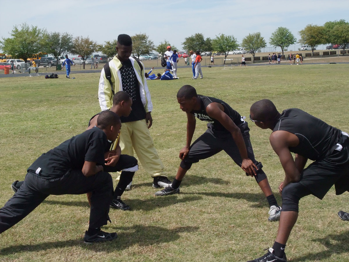 Image: Relaxing before Relays — Getting their stretch on are the four horsemen from Italy, Heath Clemons, Deandre Sephus, Darrin Moore and Desmond Anderson.