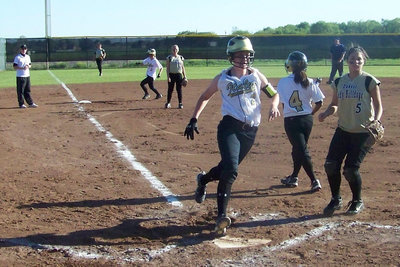 Image: One of eight — Bailey Bumpus trucks in to score one of the eight runs scored by the Lady Gladiators during the contest with Dawson.