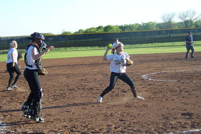 Image: Scoop and throw — Courtney scoops up a bunt and throws to first for an out.