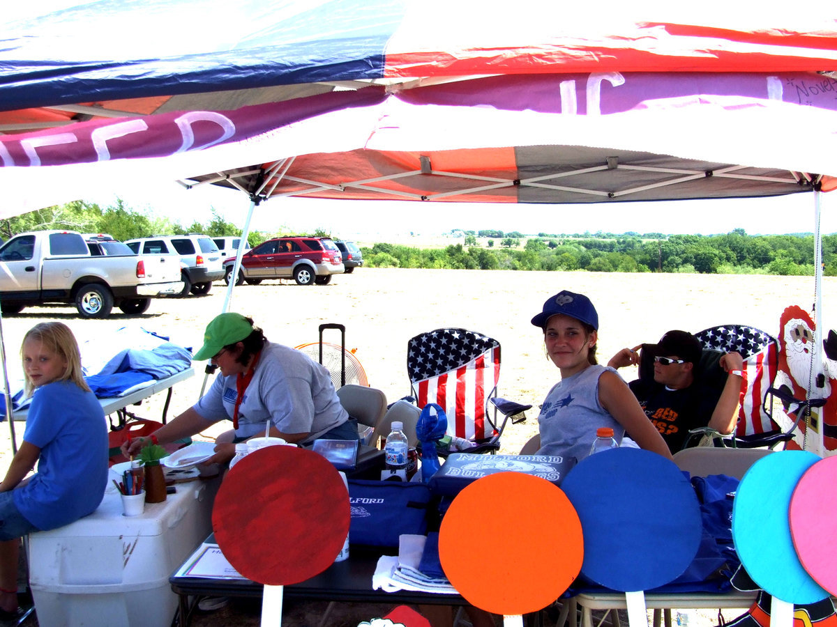 Image: Milford’s Varsity Cheerleaders Booth — Miss Crumpton is the sponsor for the Milford Varsity Cheerleaders and she said, “We are selling homemade crafts, Milford novelties, tie dye shirts, homemade cookies and treats.”