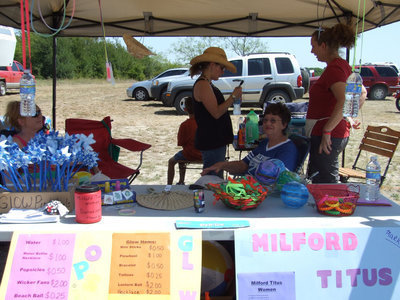 Image: Titus Women’s Booth — Jeannie Richardson is the president of the Titus Women’s club. “We are out here raising money for our youth at our school for school supplies, backpacks or whatever they need to get started in school.”