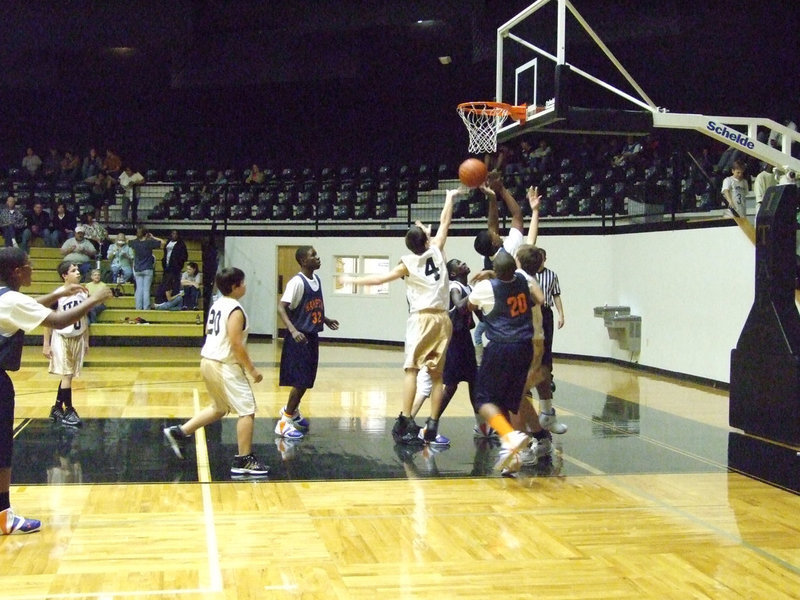 Image: Shot Block — Italy’s #4 Tony Wooldrige blocks a shot by Hampton.