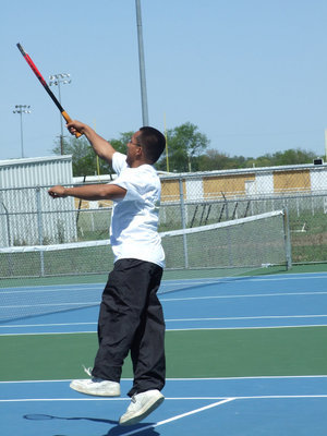 Image: Controlling the net — Jacob Lopez works hard at the net.