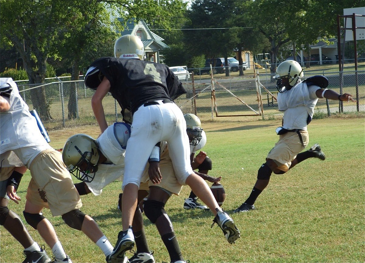 Image: Gladiators kick it into high gear this week against Maypearl — Jasenio Anderson kicks the simulated P.A.T. (point after touchdown) during Wednesday’s practice as the Gladiators get tuned up for the Mayperal Panthers.