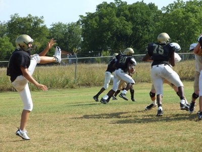 Image: Kyle connects — Kyle Jackson punts for the JV during practice.