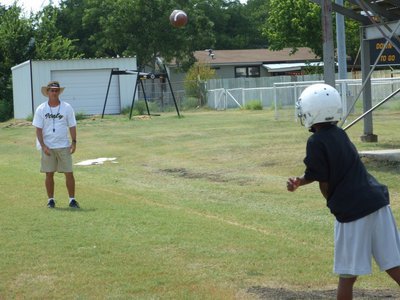Image: Carson to Coach — Coach Kyle Holley worked with the Jr. High quarterbacks on Wednesday.