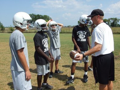 Image: Coach Ward teaches — Coach Josh Ward talks technique with the receivers.